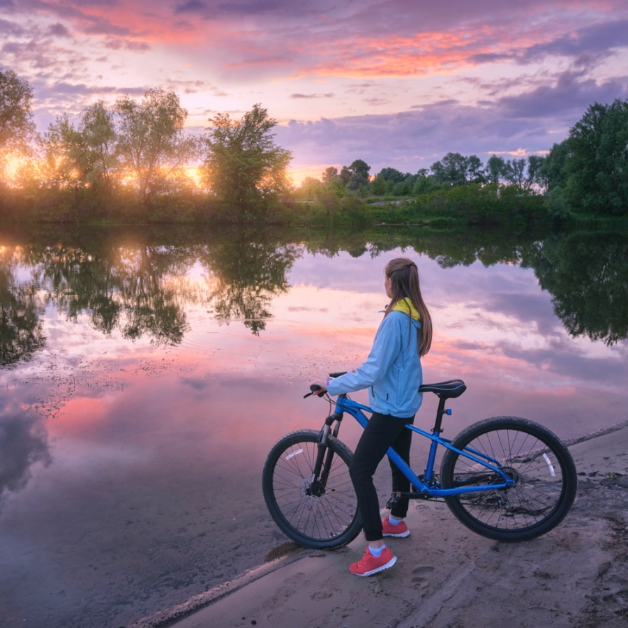 woman-with-bicycle-on-the-coast-of-the-river-at-su-2024-12-04-21-31-04-utcSquare - Copy